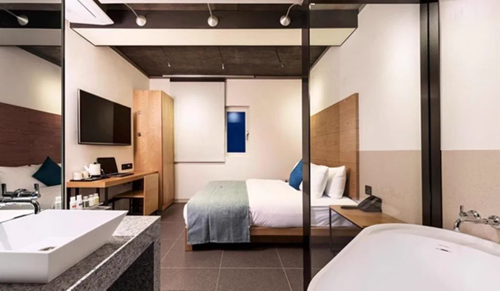 Guest room and bed layout at Delight Hotel Jamsil