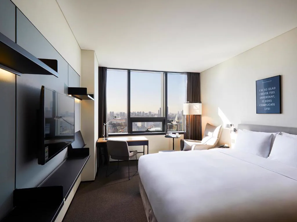 Interior of a GLAD Mapo guest room with a desk by the window
