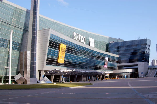 Exterior of BEXCO in Busan with the convention centre entrance and forecourt visible